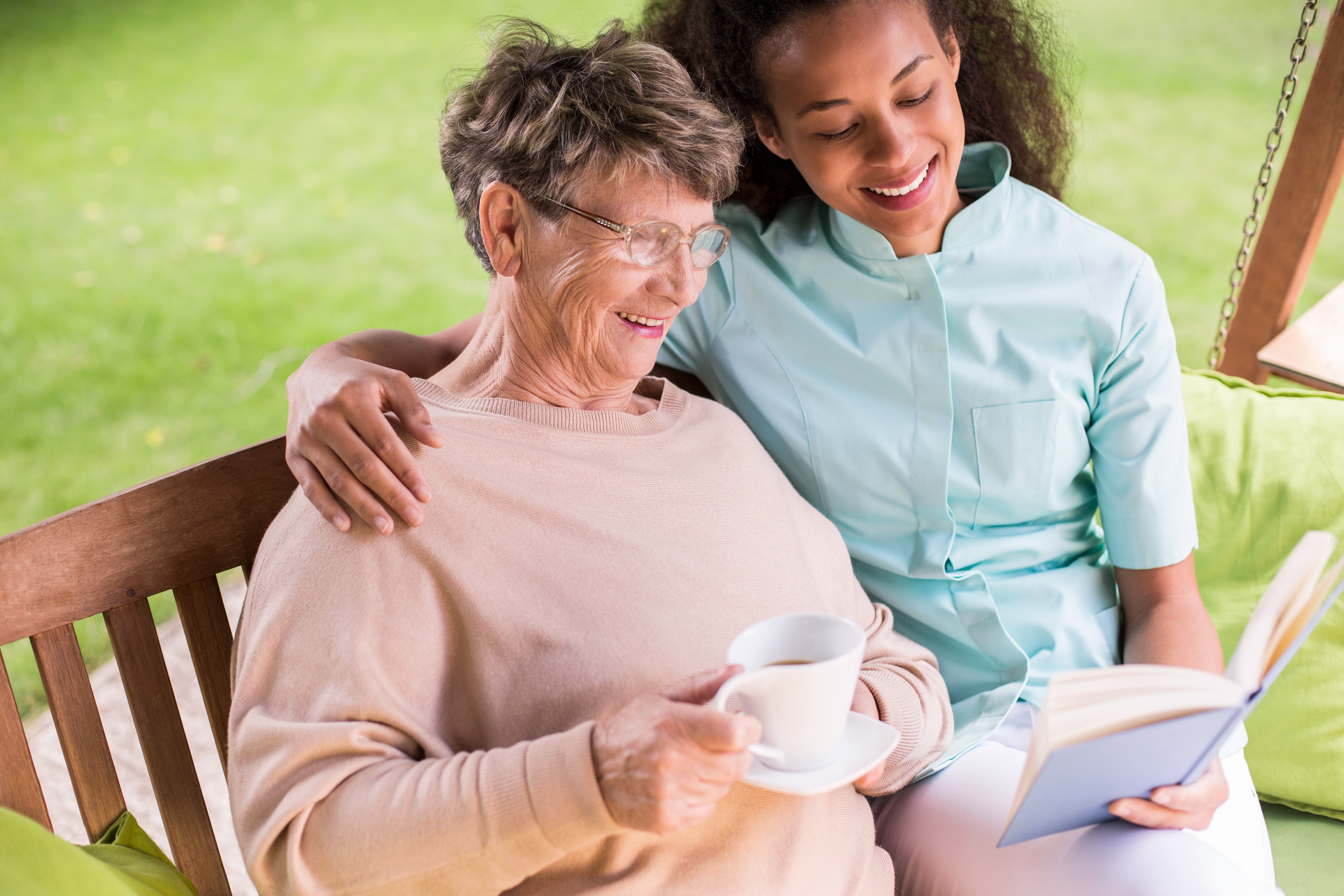 Caregiver reading to woman